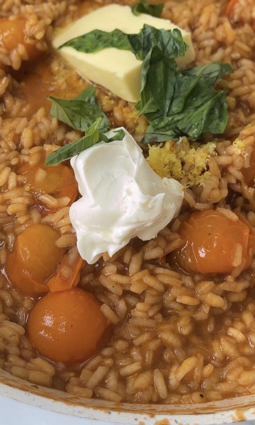 finishing tomato mascarpone risotto with butter.