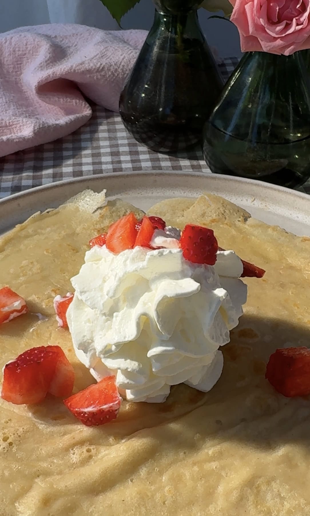 adding whipped cream and strawberries.