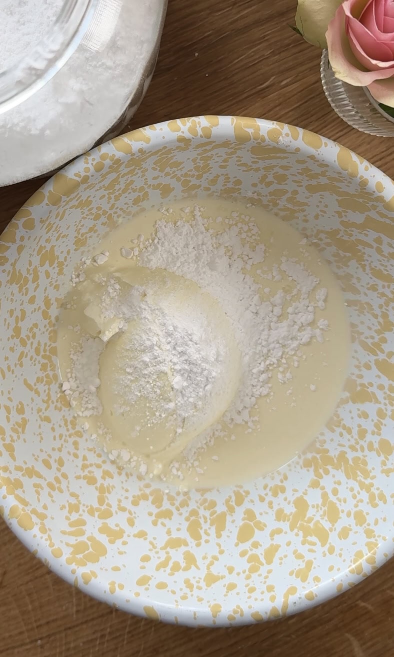 adding mascaroone, double cream and sugar to a bowl. 