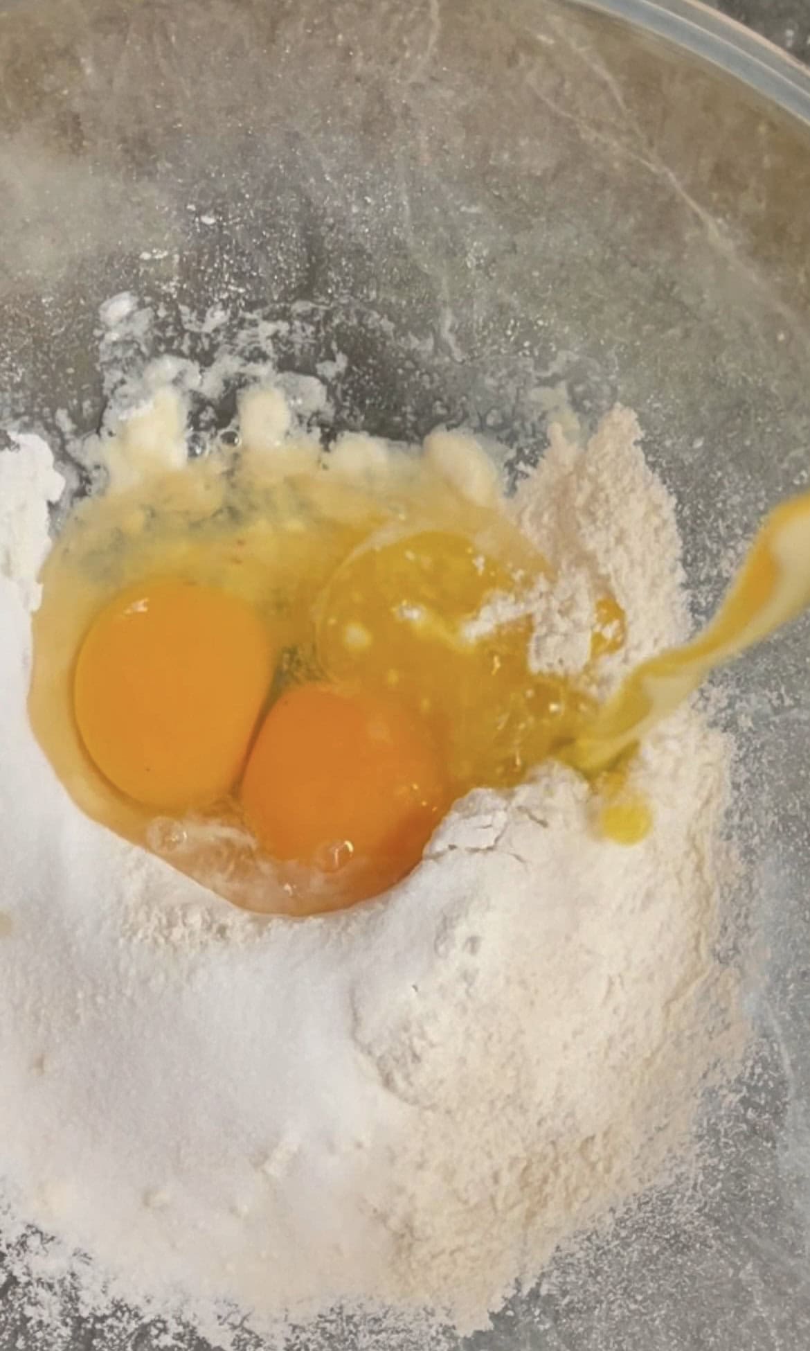 mixing eggs, flour, sugar, butter for crepe batter. 