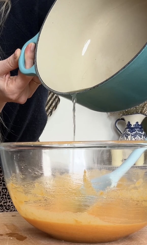 pouring hot lemon juice into the curd.