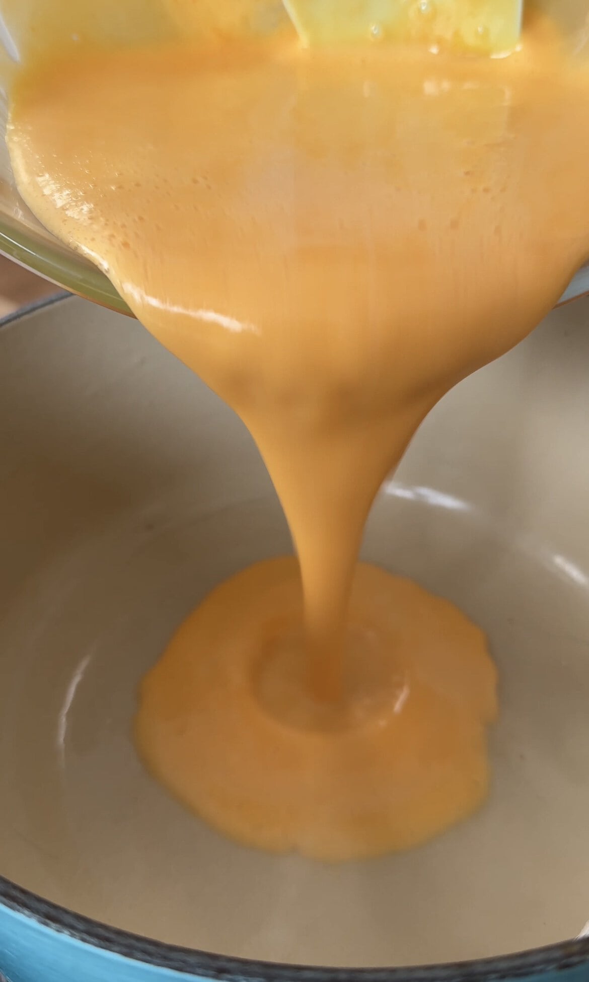 pouring lemon curd back into the pot.