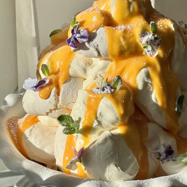 lemon meringues tower with lemon curd and edible flowers.