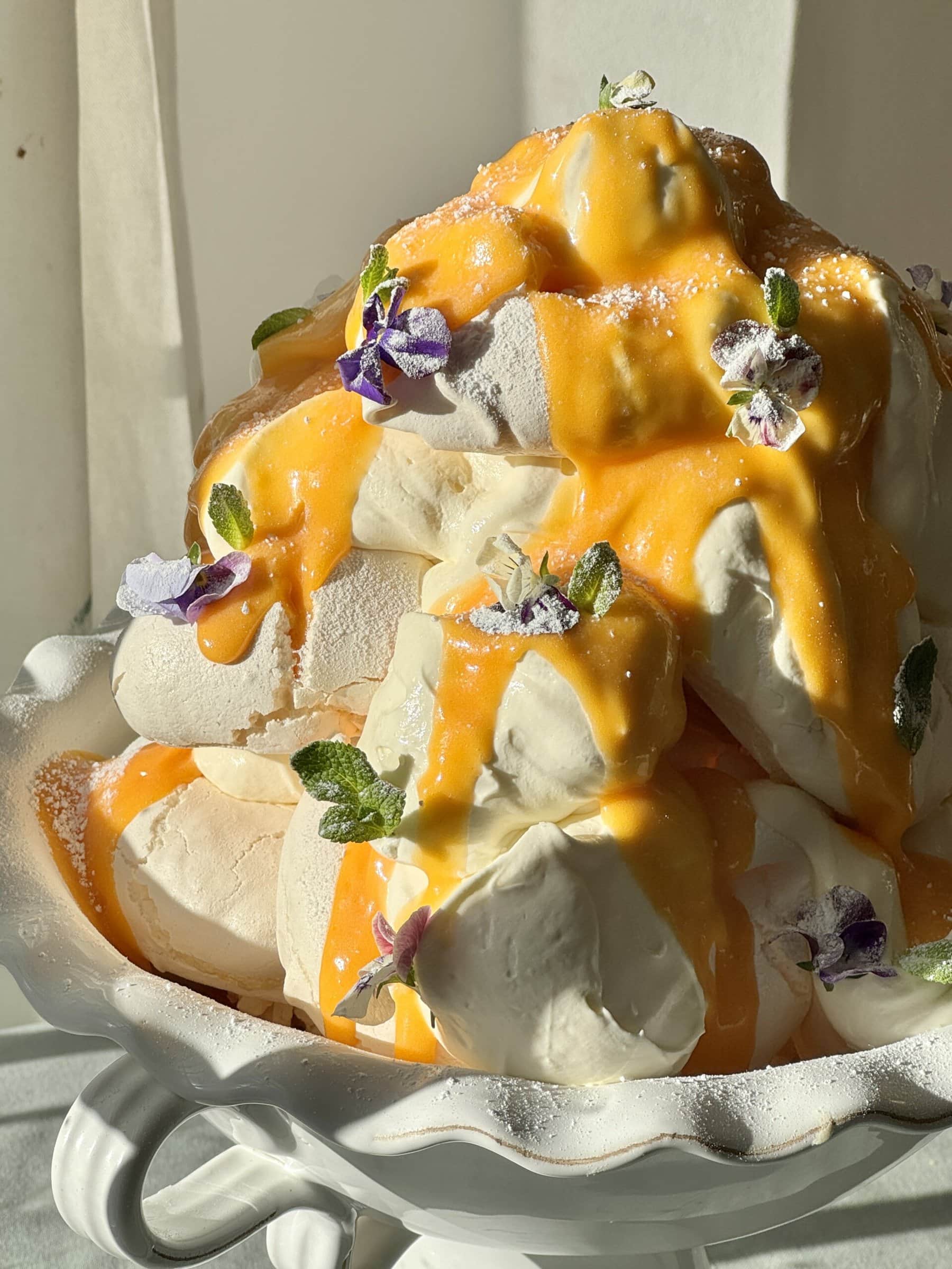 lemon meringues tower with lemon curd and edible flowers.