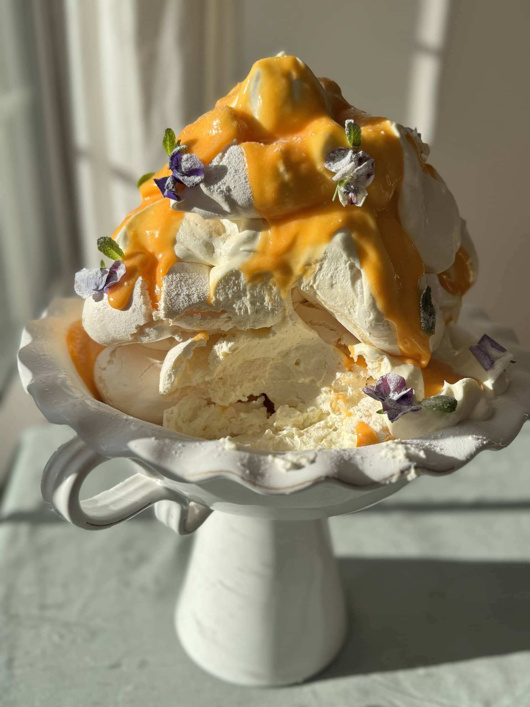 lemon meringues tower with lemon curd and edible flowers.