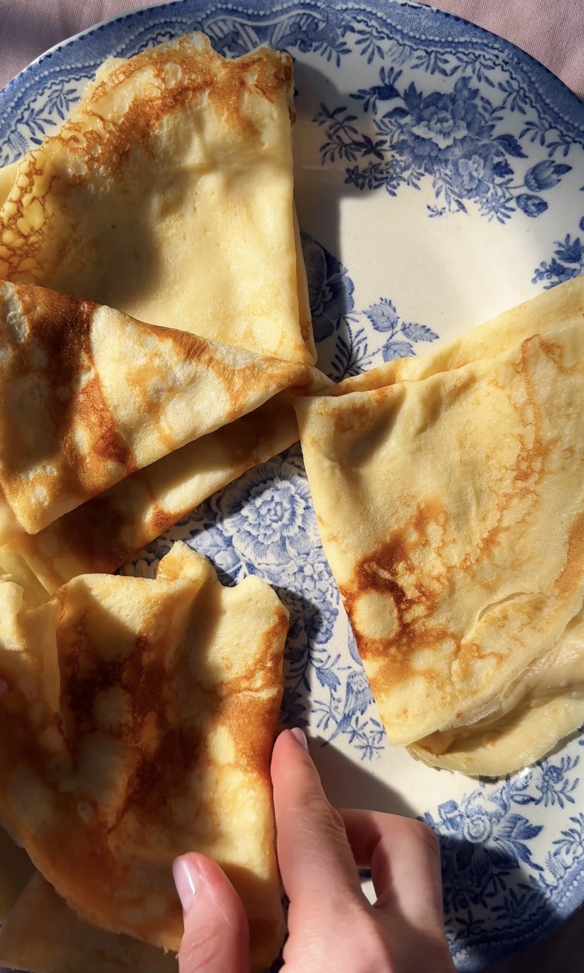 arranging pannekaken on a blue plate.