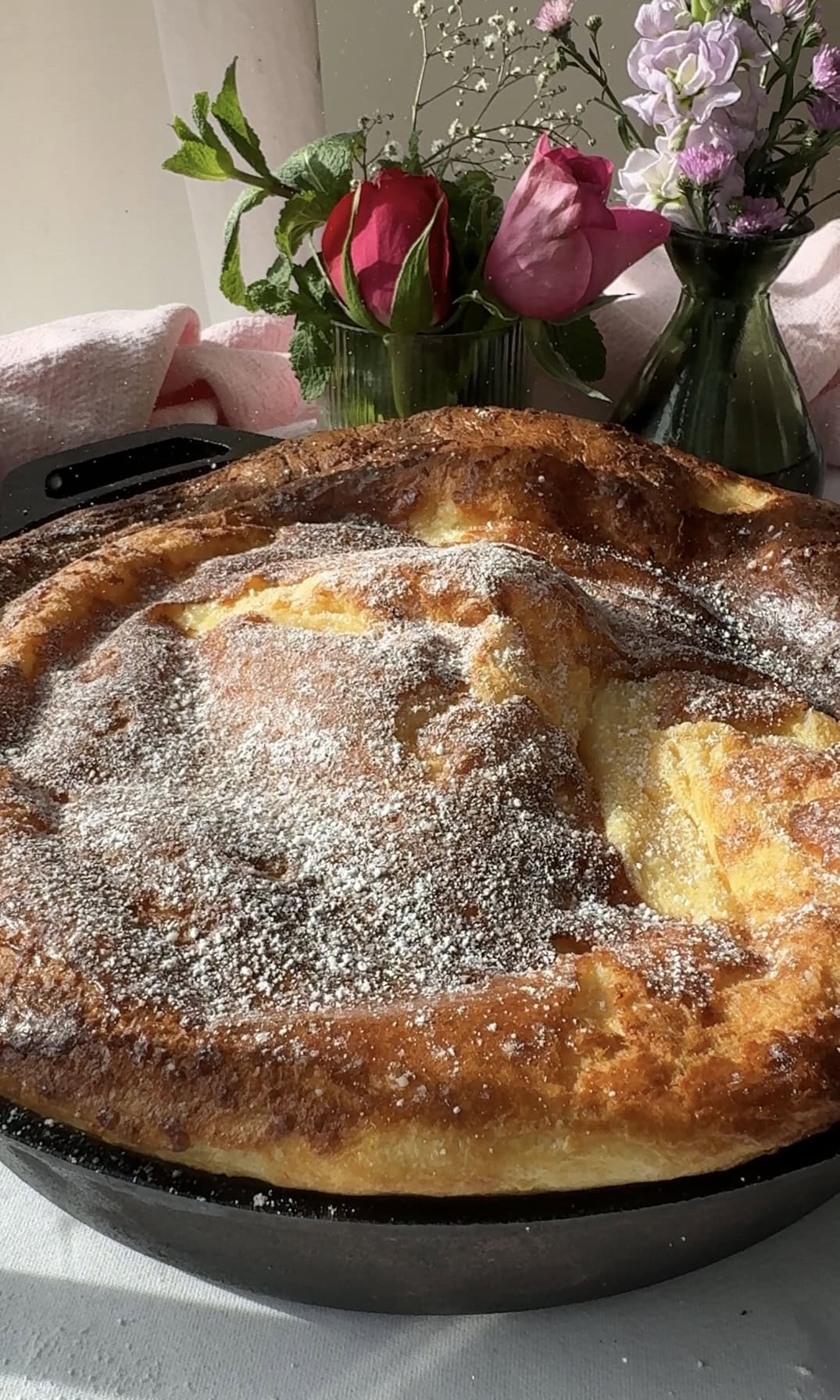 dusting pannukakku with icing sugar.