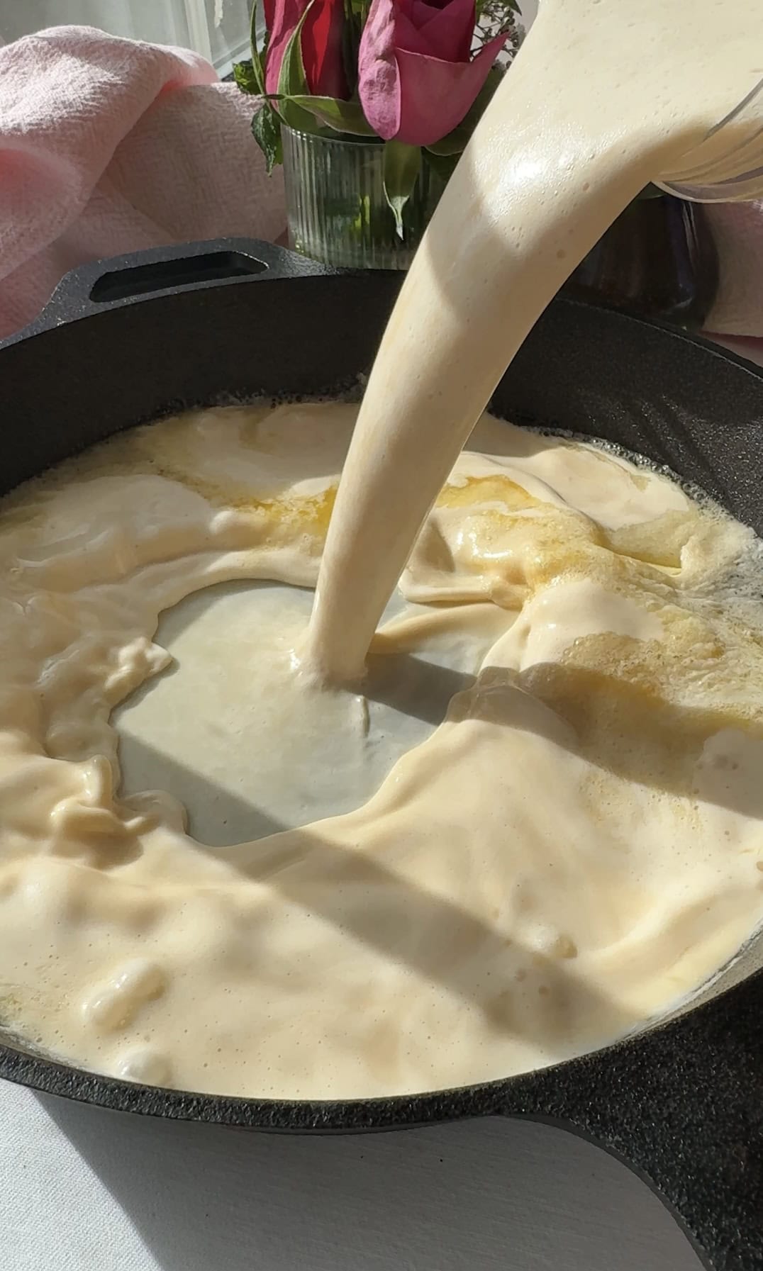 pannukakku batter adding to pan.