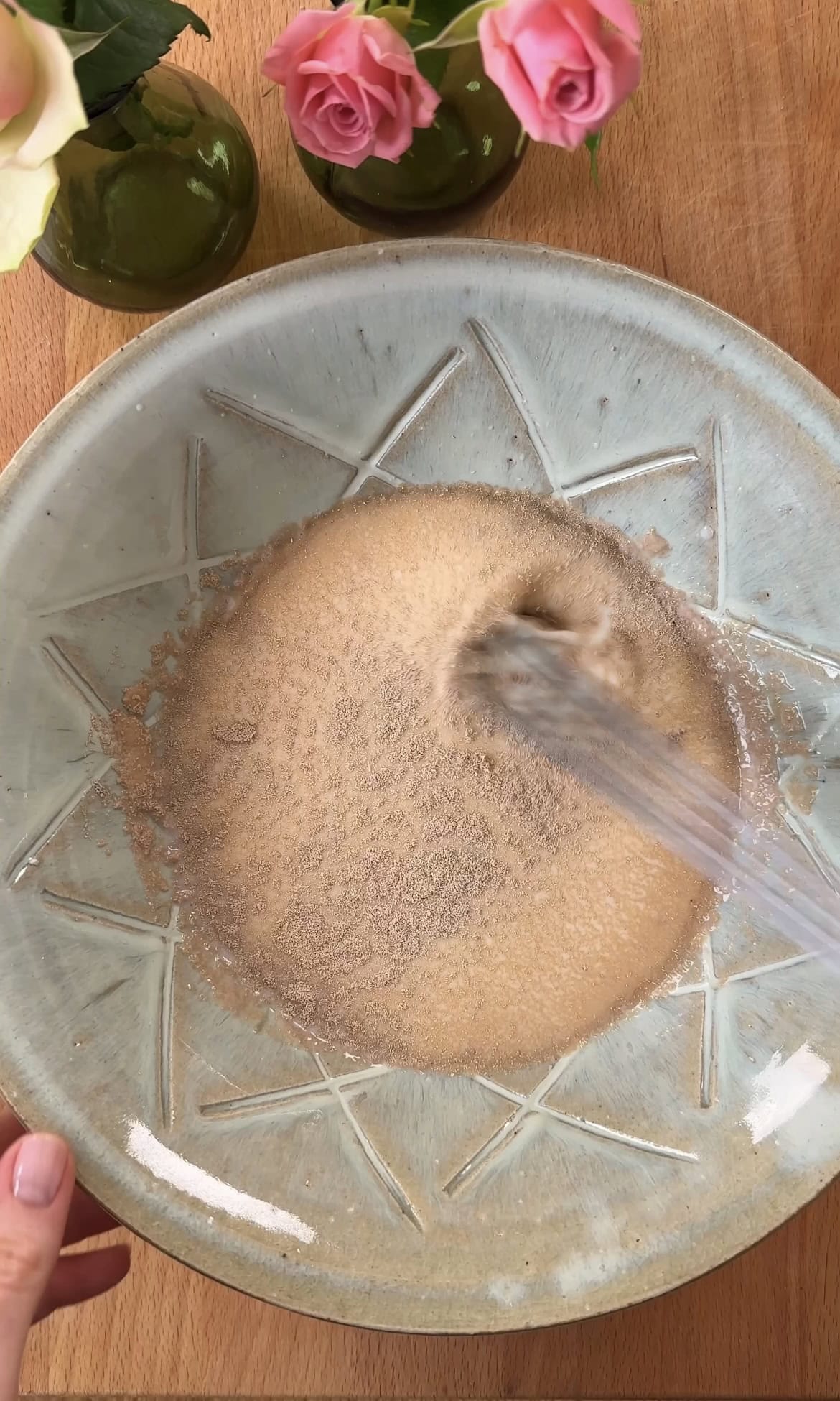 whisking yeast into milk.