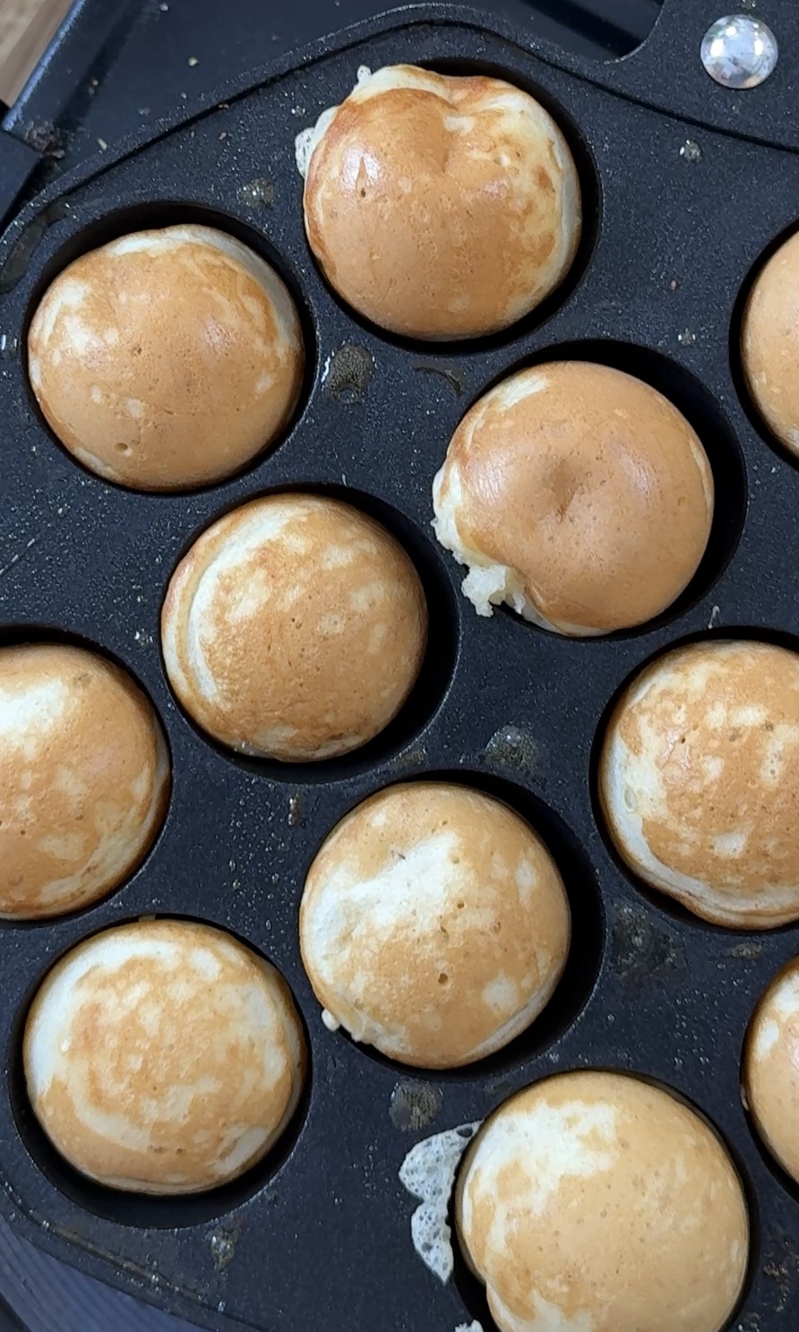 flipping poffertjes in the pan.