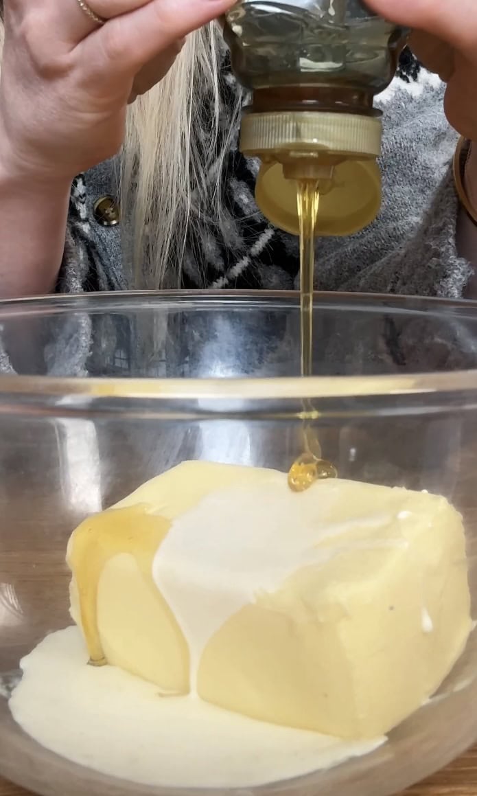 adding honey to butter.