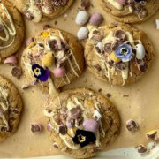 mini egg cookies drizzled with white chocolate with edible flowers.
