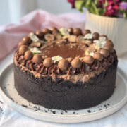 whole no-bake chocolate cheesecake with chocolate decorations.