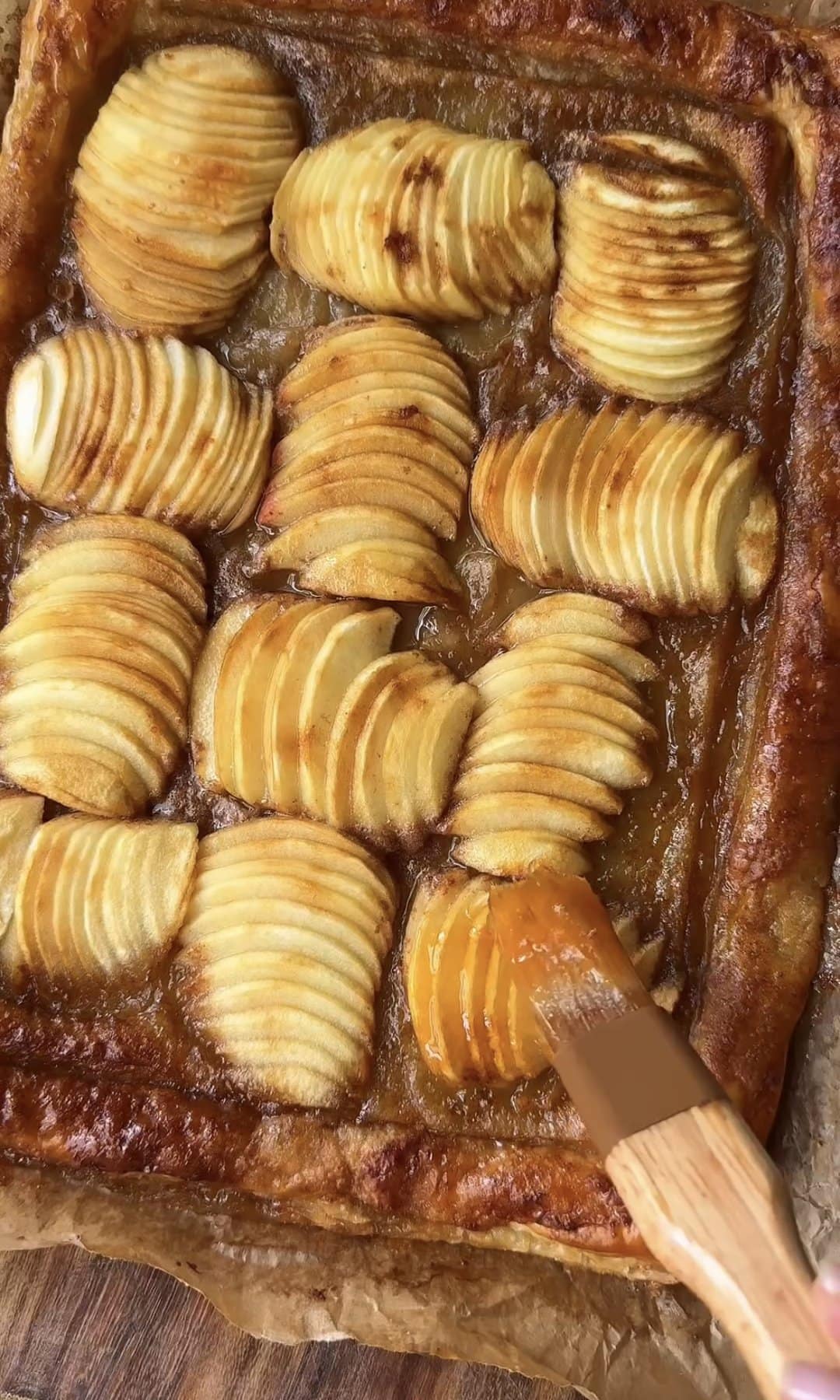 brushing apple tart with apricot jam.