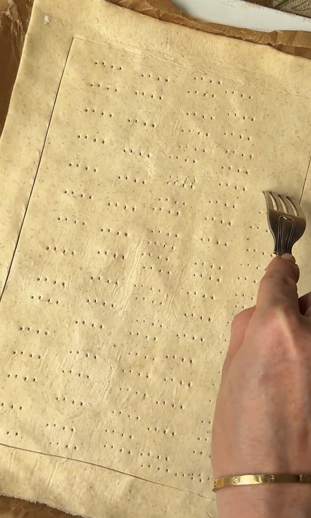 pricking puff pastry with fork.