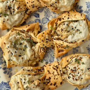 spinach feta filos bows on a blue plate.