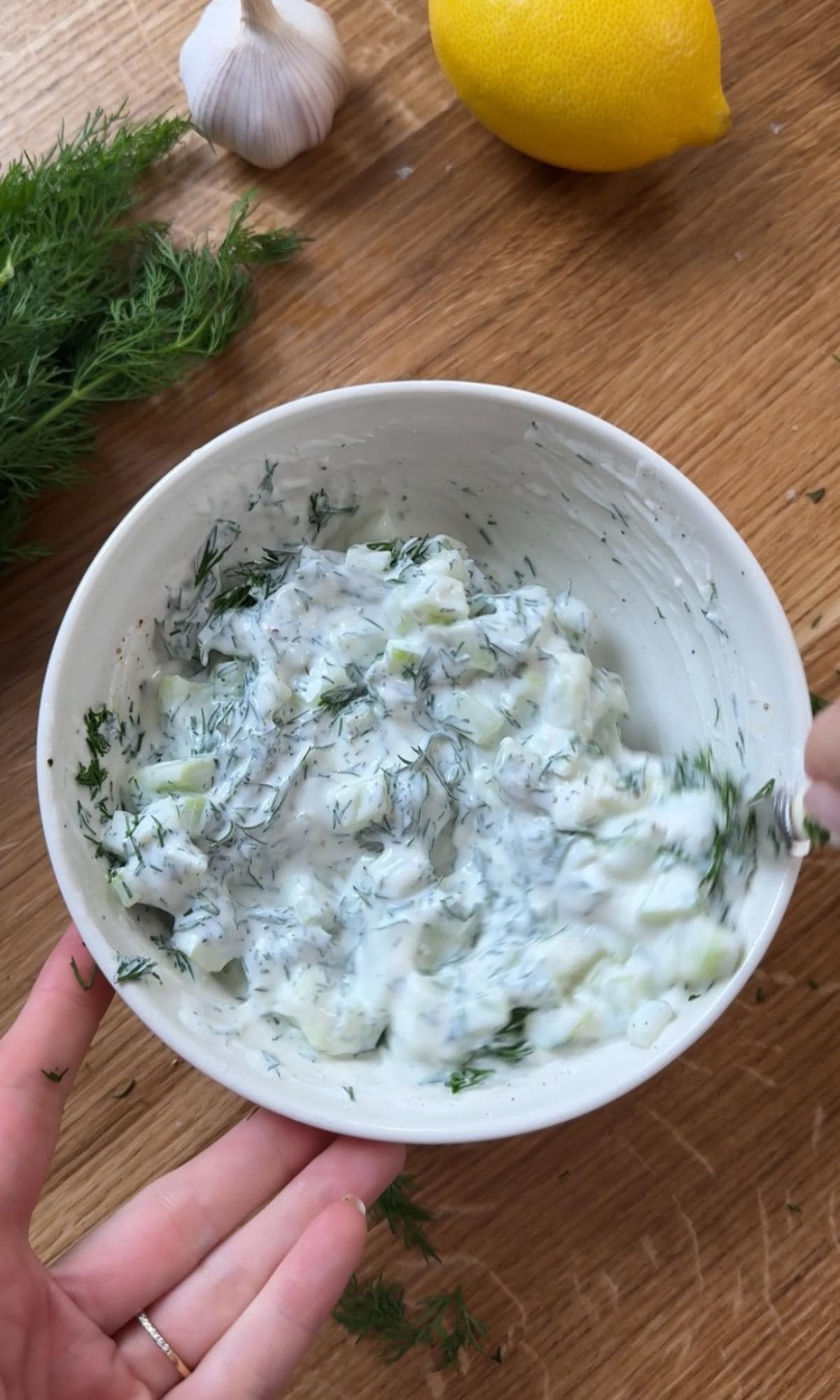 mixing cucumber yoghurt.