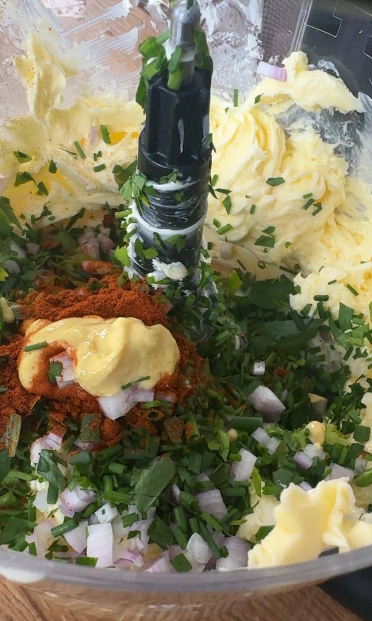 adding ingredients to a blender for cafe de paris butter.