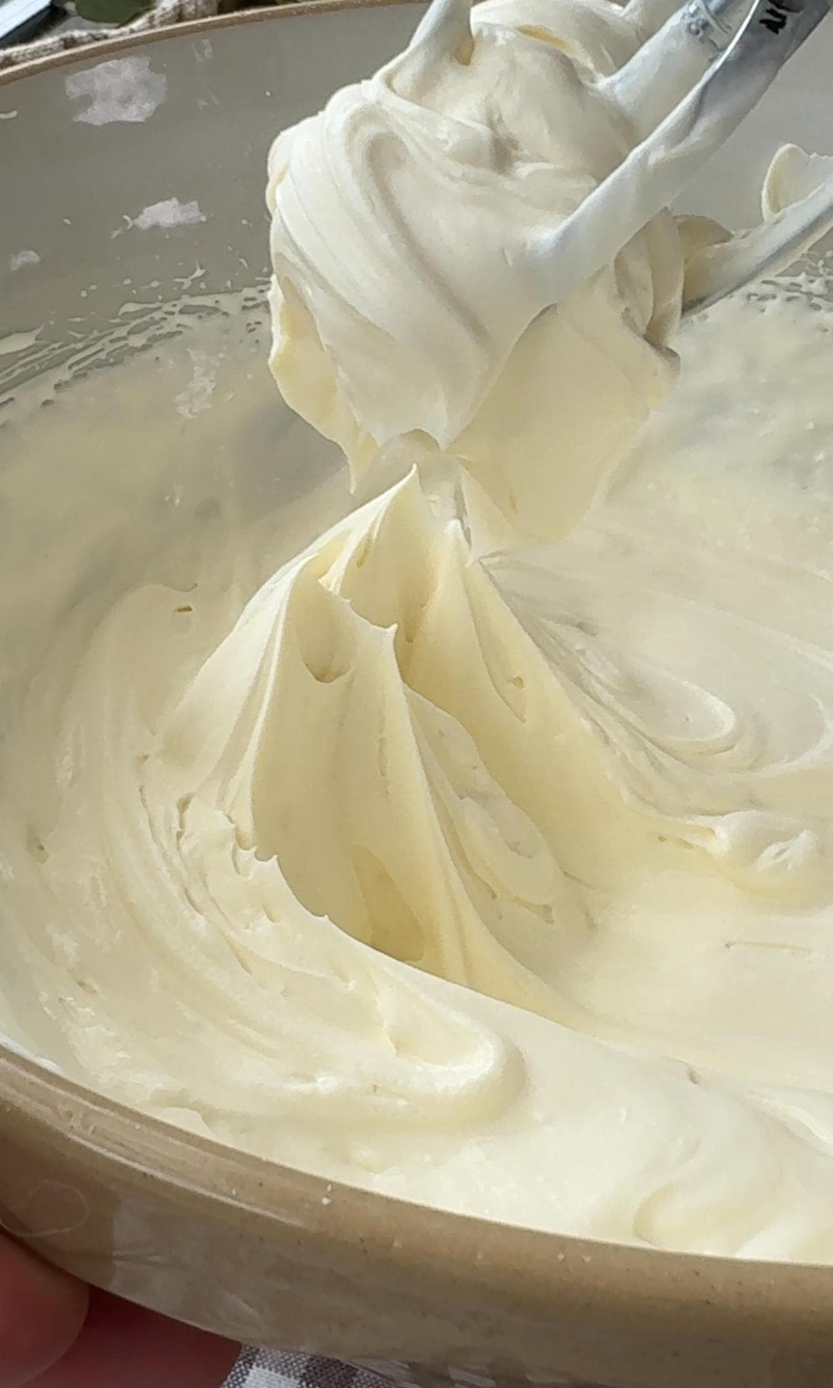 whisking double cream, cream cheese and icing sugar,