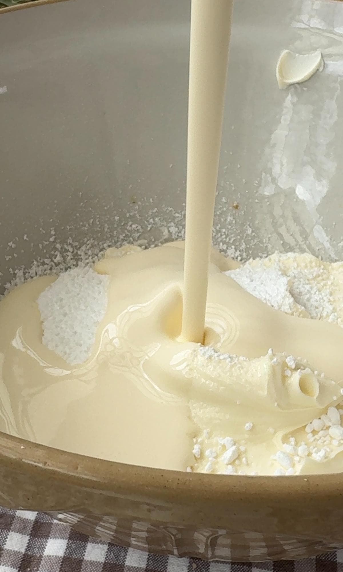 adding double cream to cheesecake.