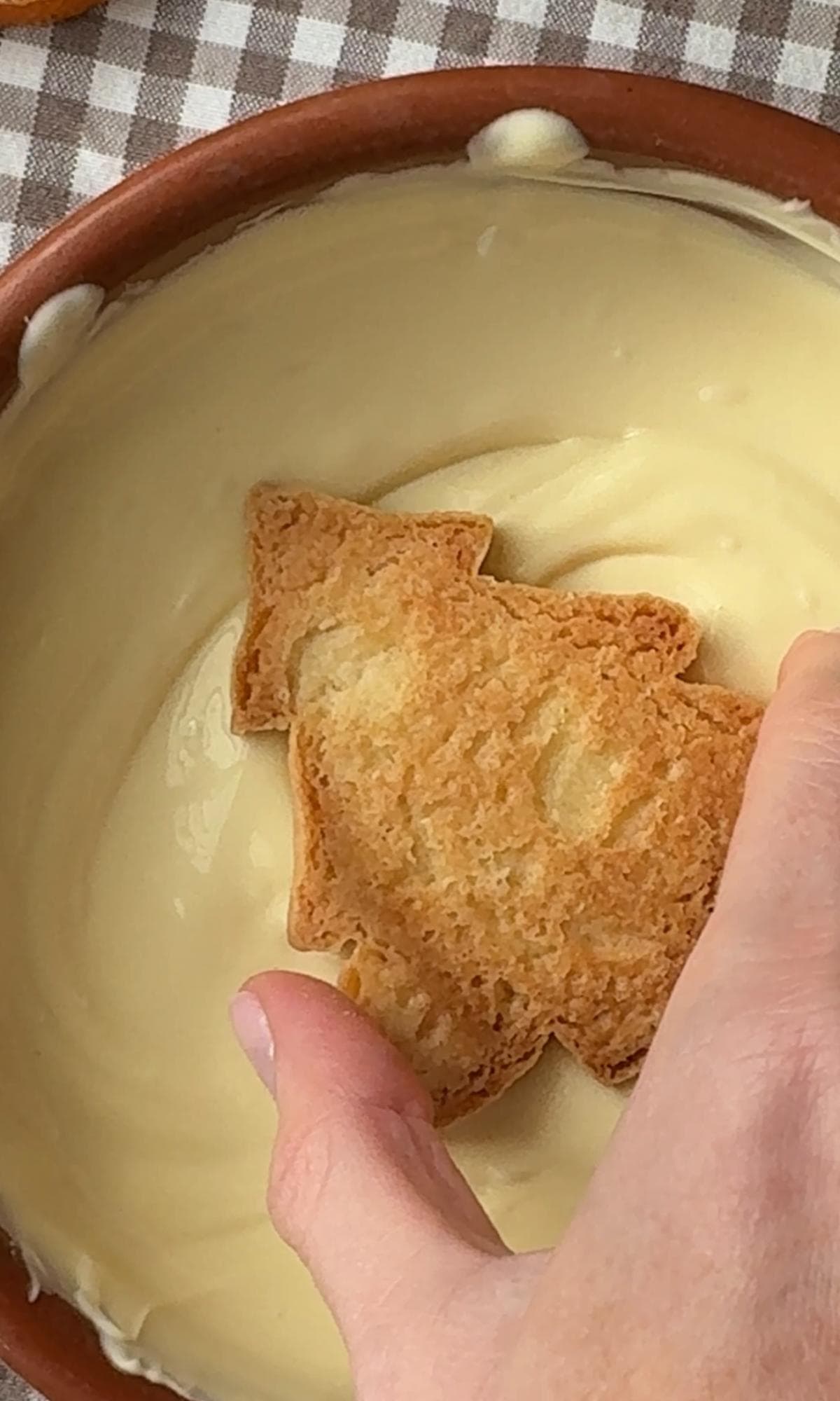dipping christmas tree cookies into white chocolate.