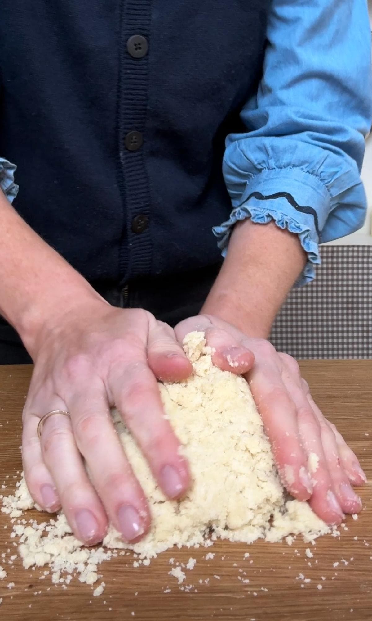 bringing the dough together with hands.