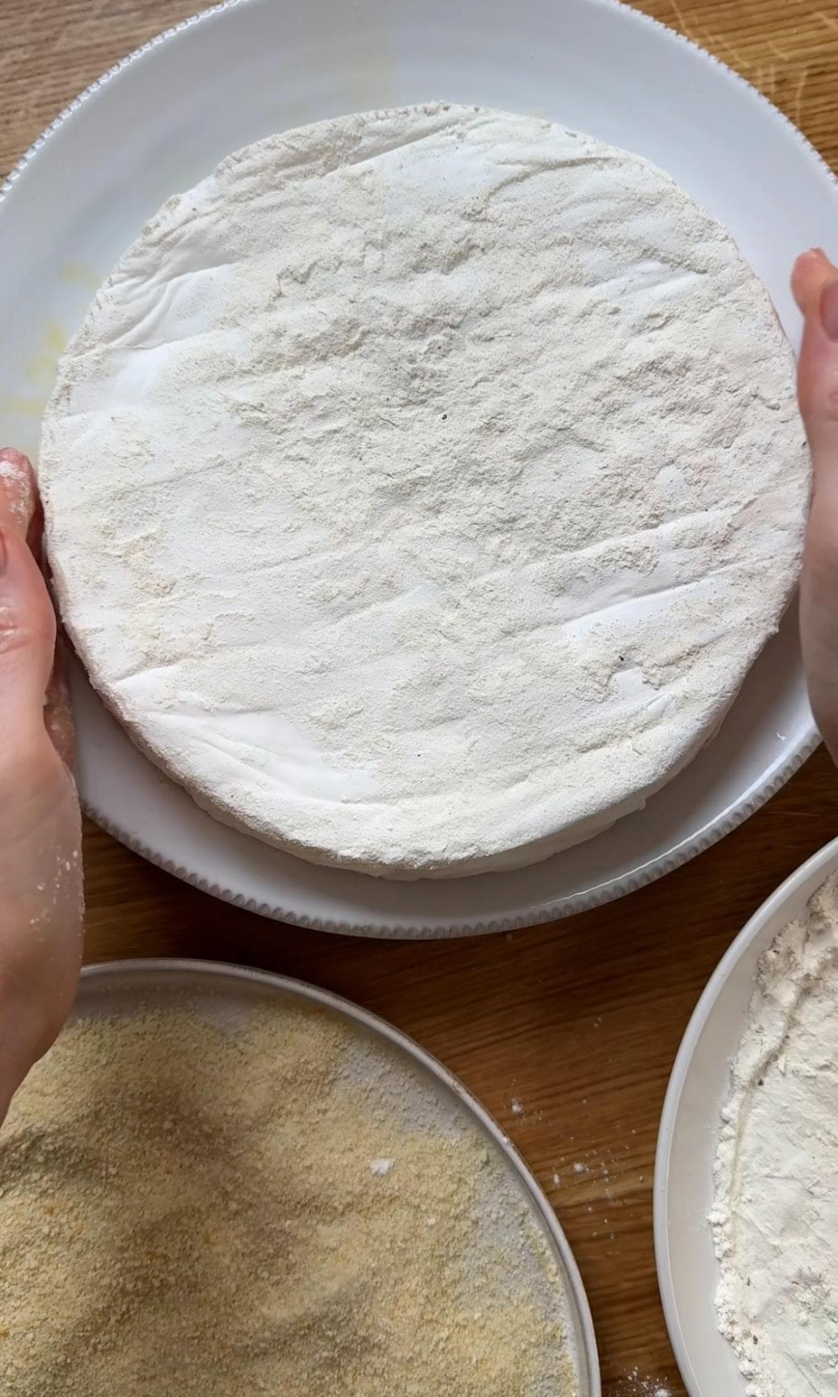 dunking brie in eggs and flour.