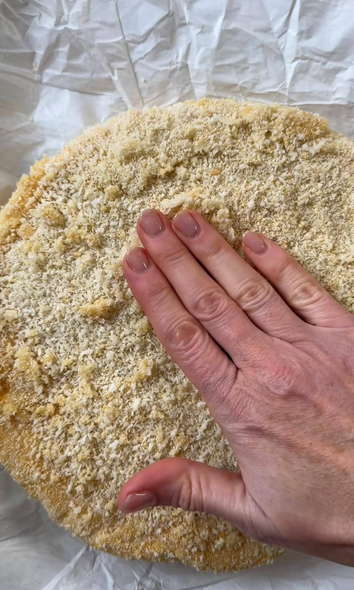 packing panko crumbs onto the brie,