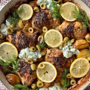 greek chicken lemon potatoes in a white dish.