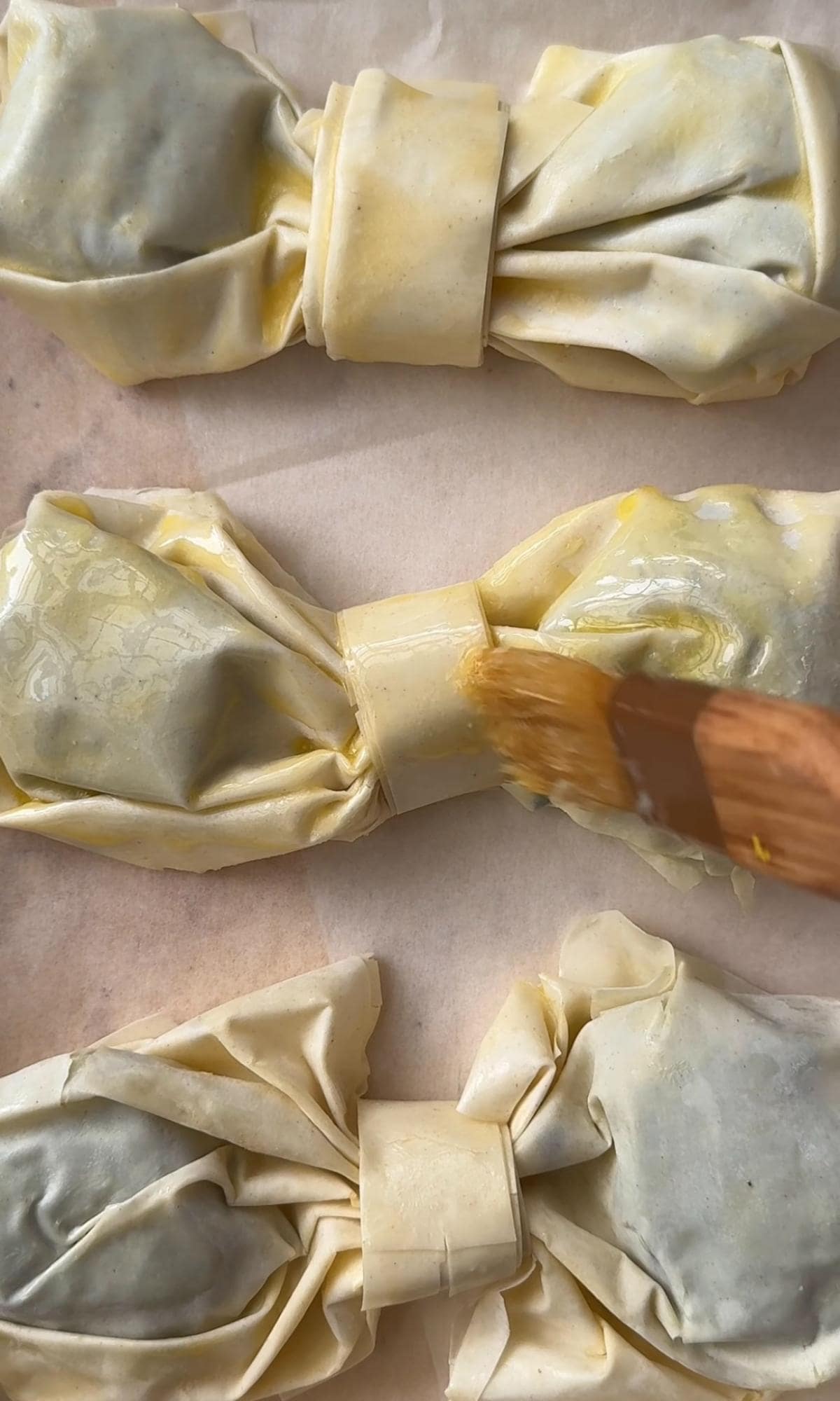 brushing filos with melted butter.