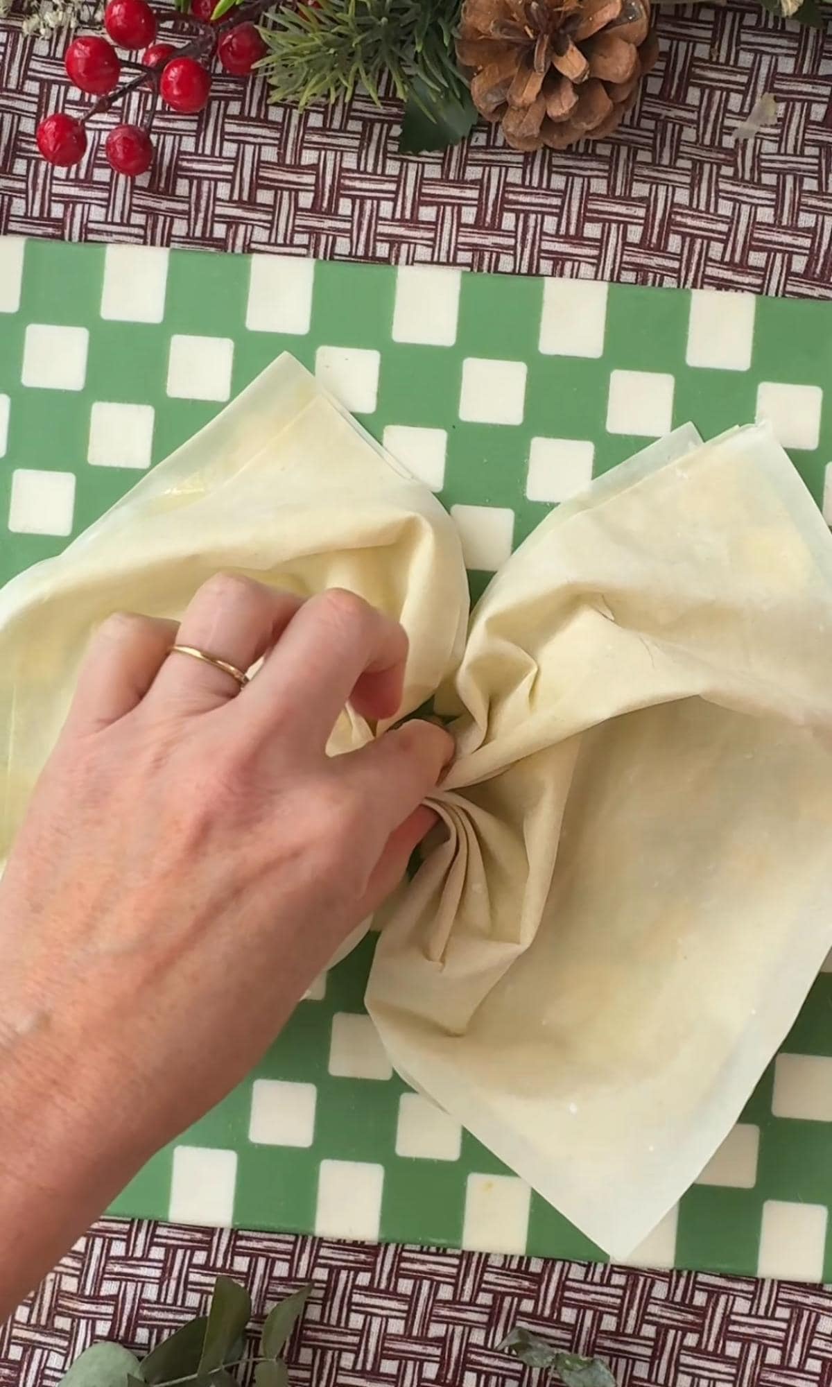 pinching the filo pastry to make a bow.