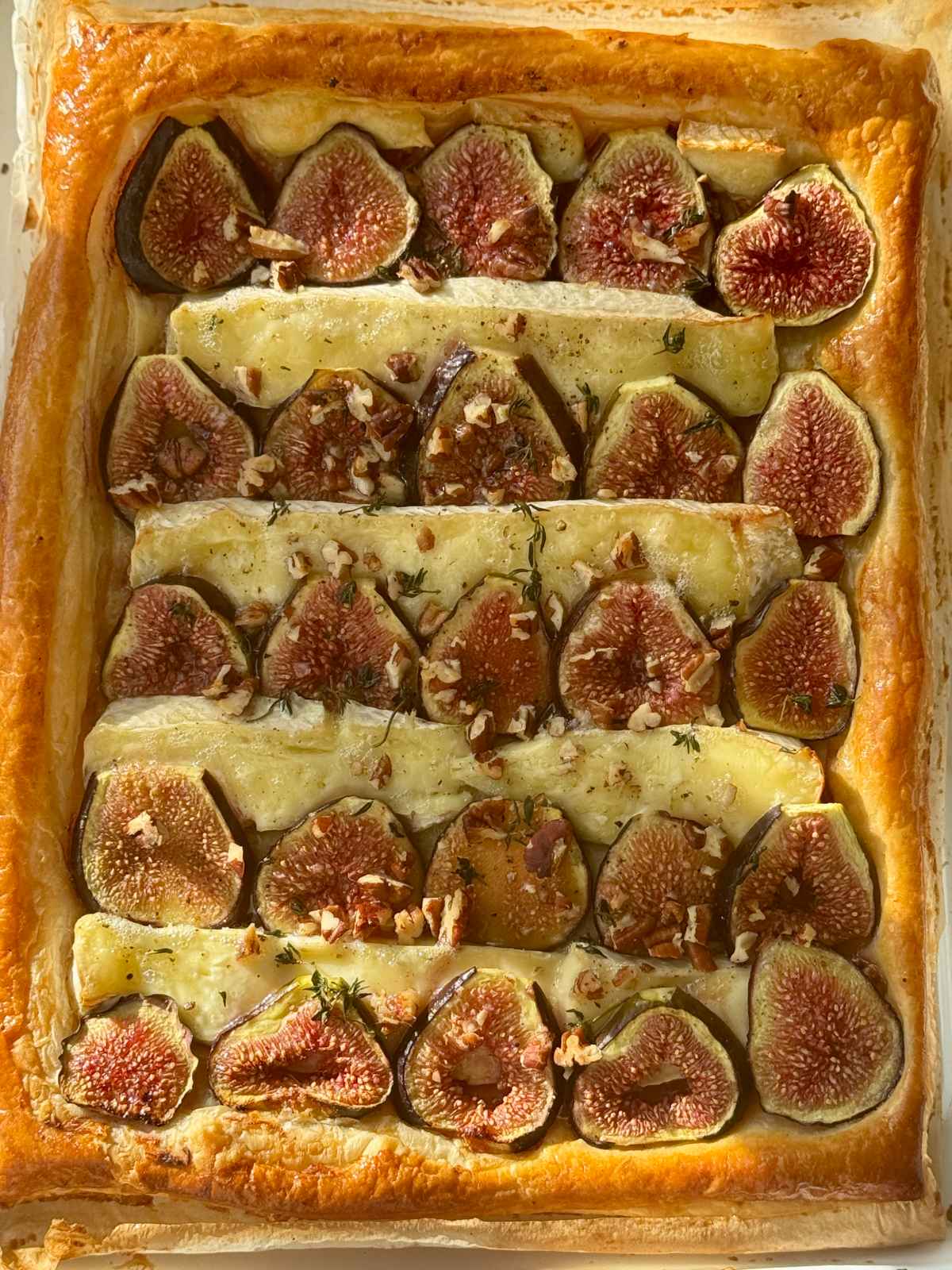 fig and brie tart on parchment paper.