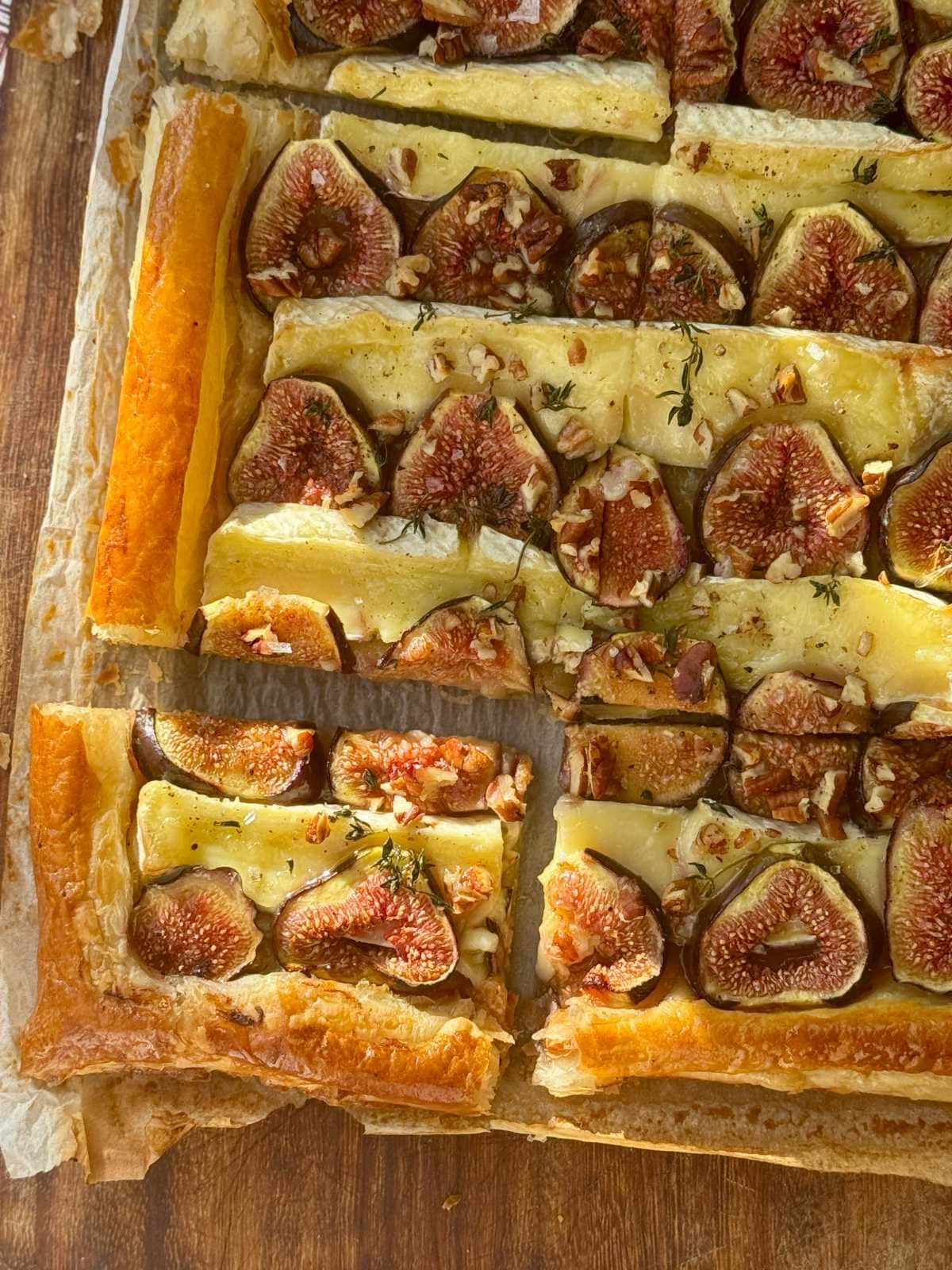 fig and brie tart on parchment paper.