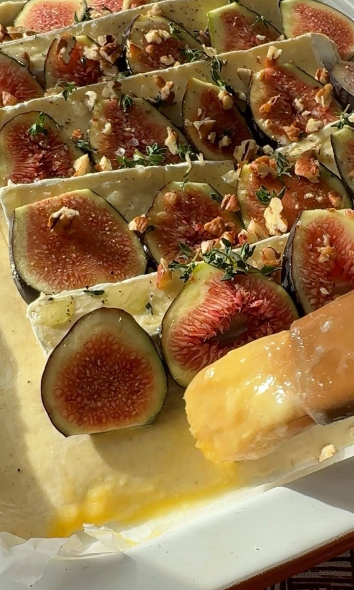brushing egg wash on tarte aux figues.