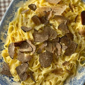 truffles with pasta on a plate.
