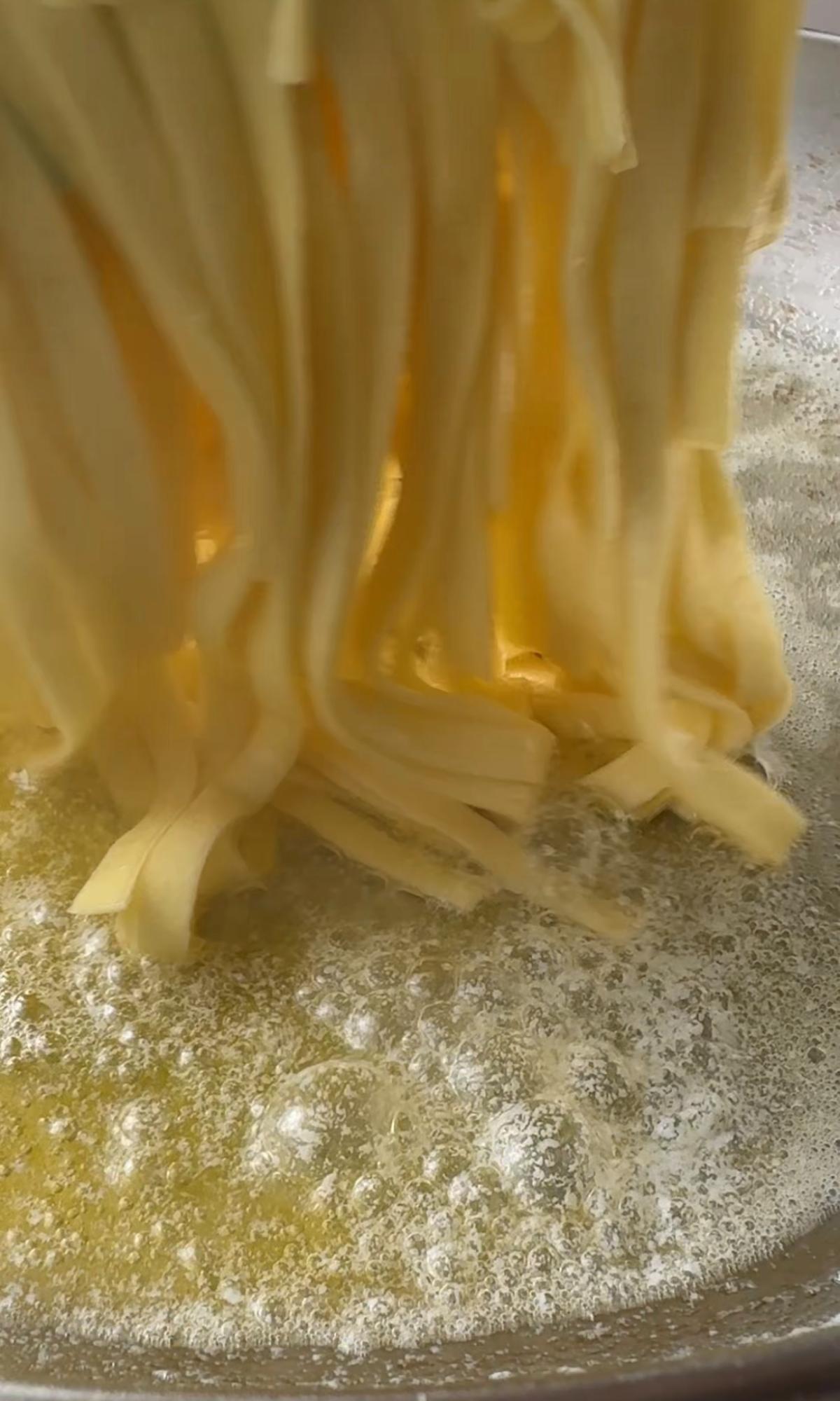 adding pasta to melted butter.
