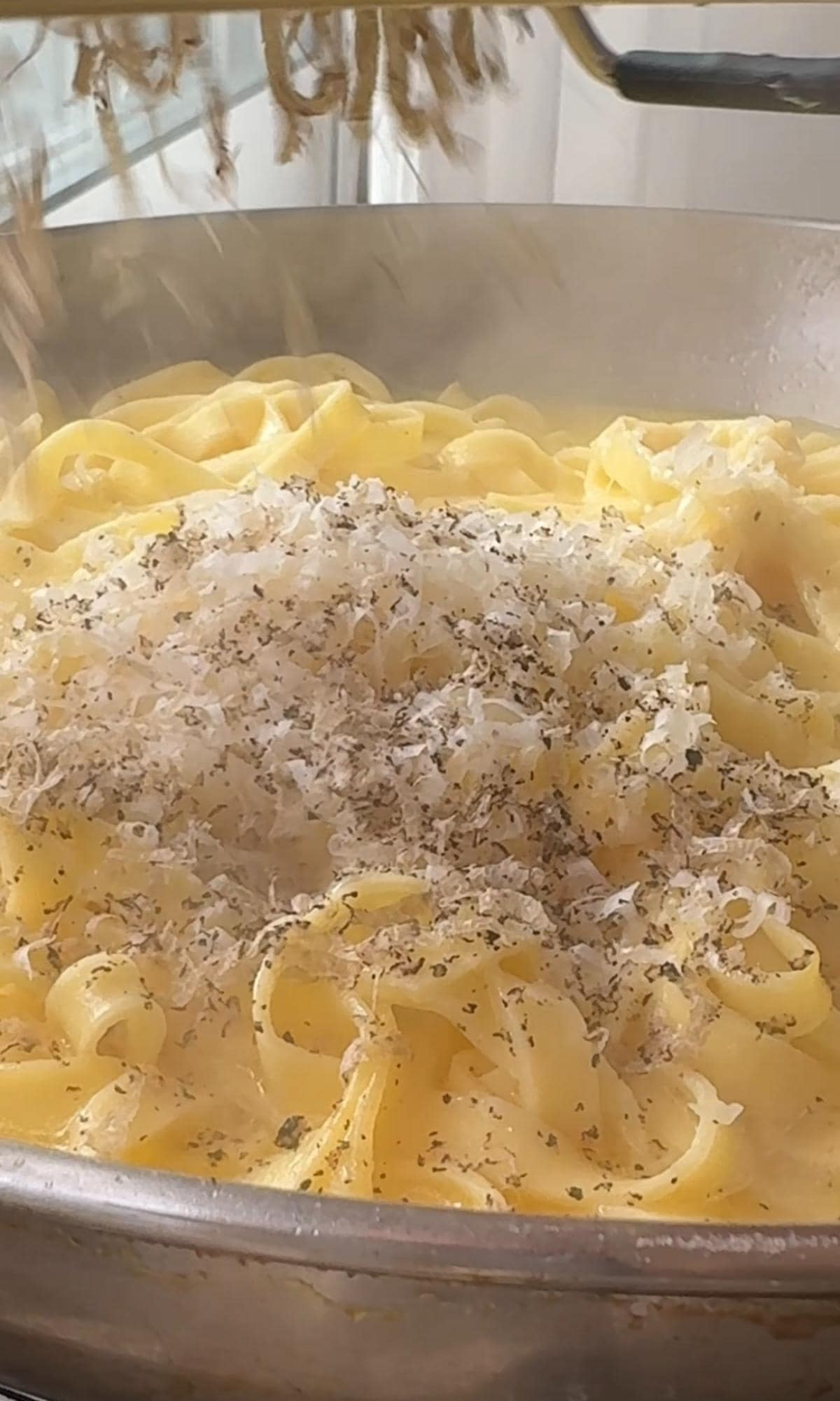 grating truffle into pasta.