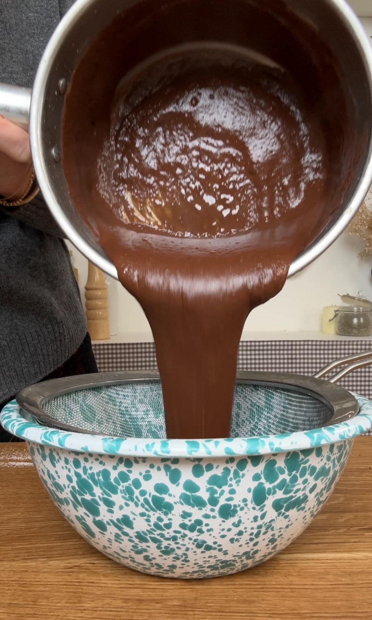 straining budino mixture through a fine sieve.