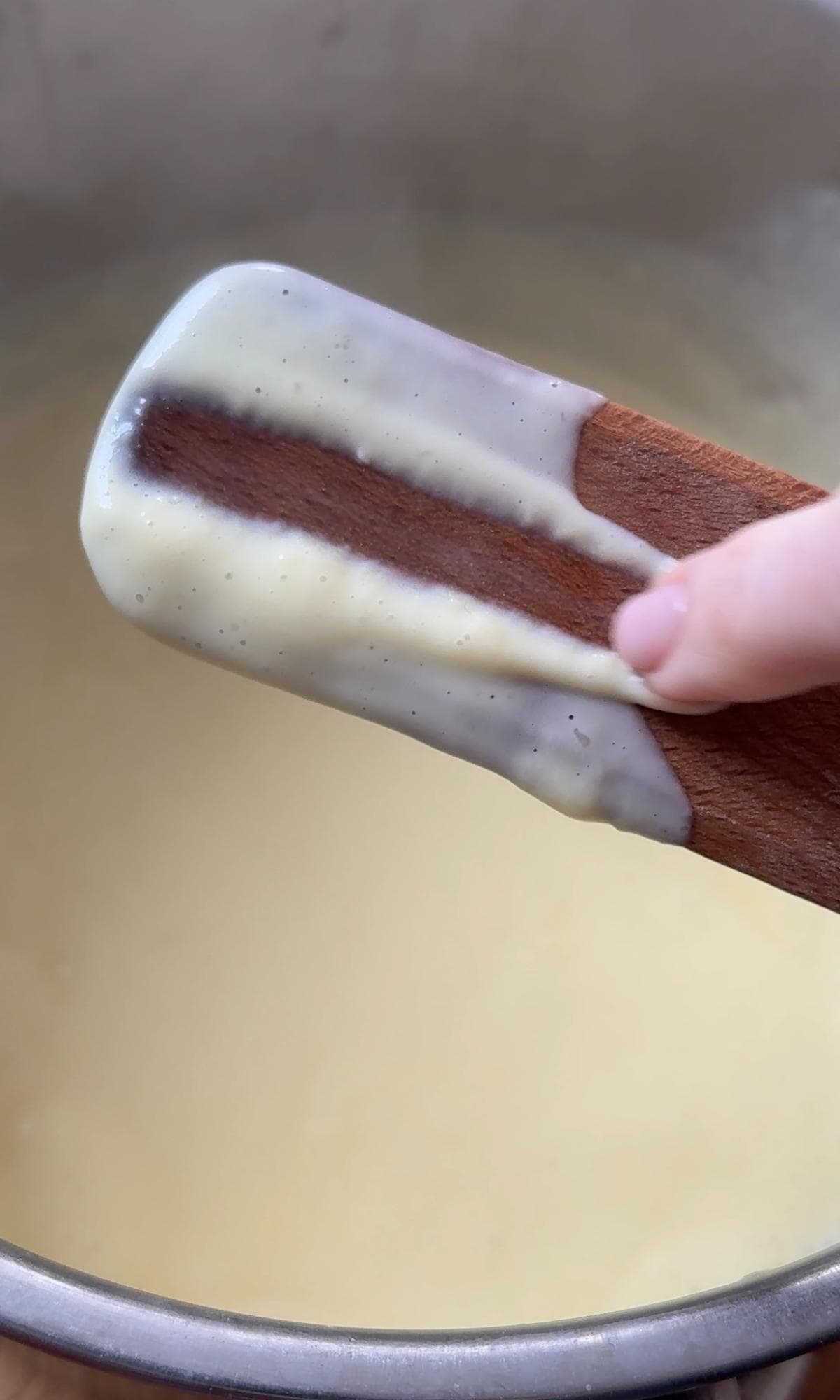 checking if the custard is set enough with the spoon test.