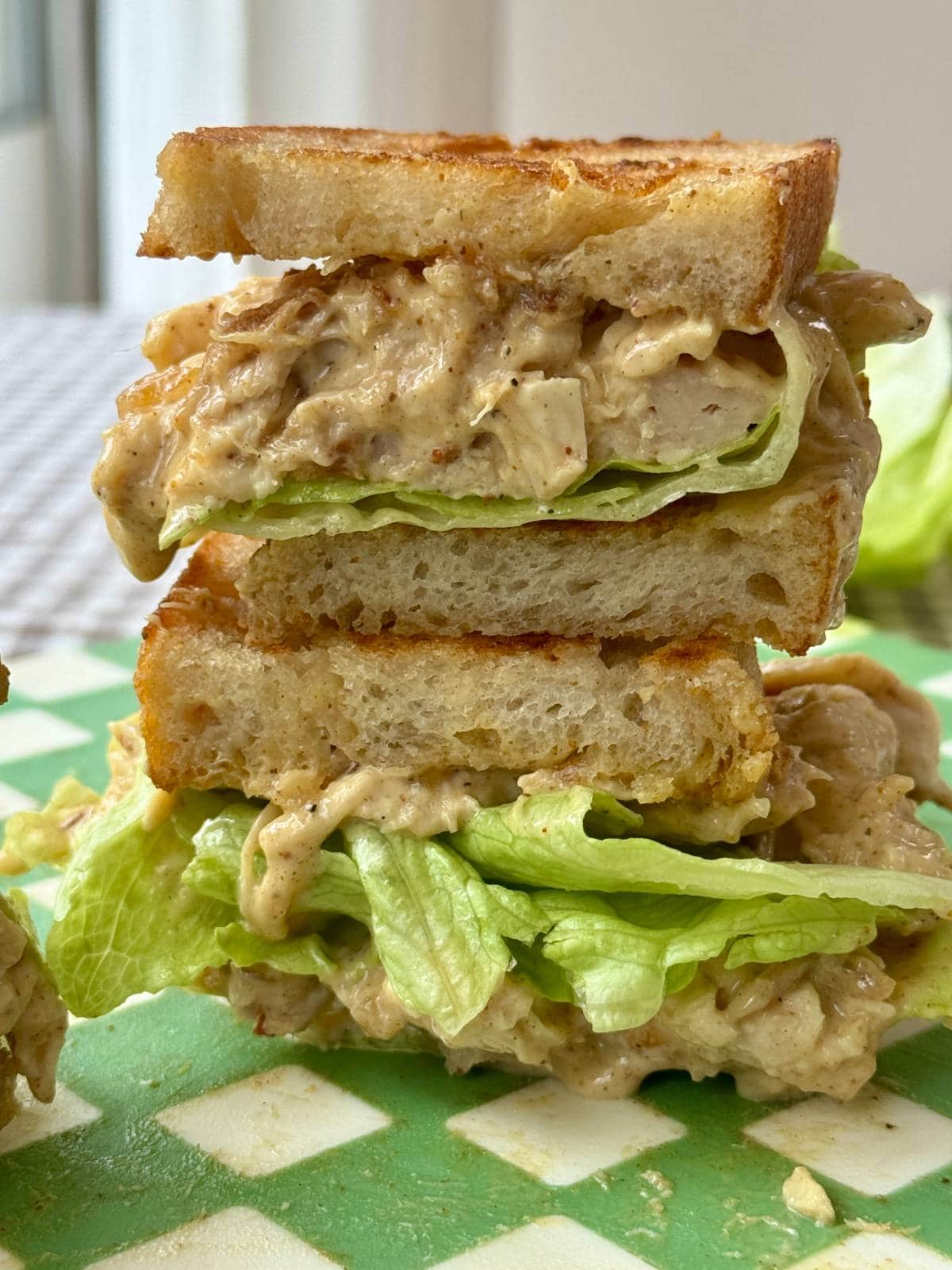 chicken coronation sandwich in half with lettuce.
