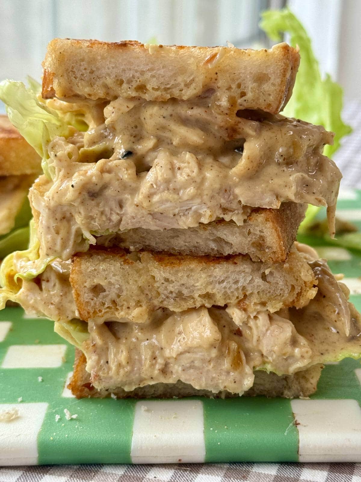 chicken coronation sandwich in half with lettuce.
