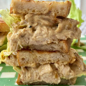 chicken coronation sandwich in half with lettuce.