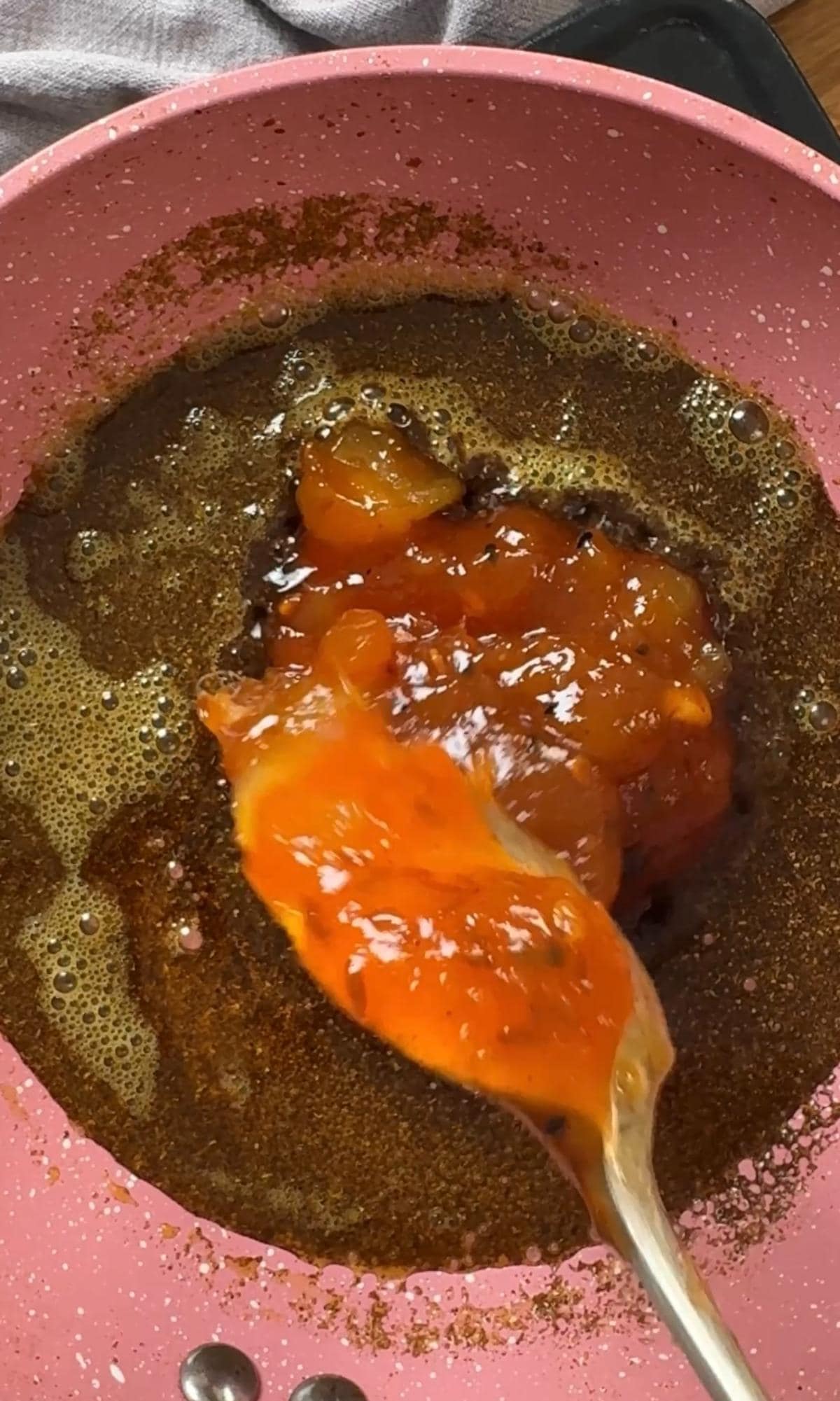 adding mango chutney to curry powder.