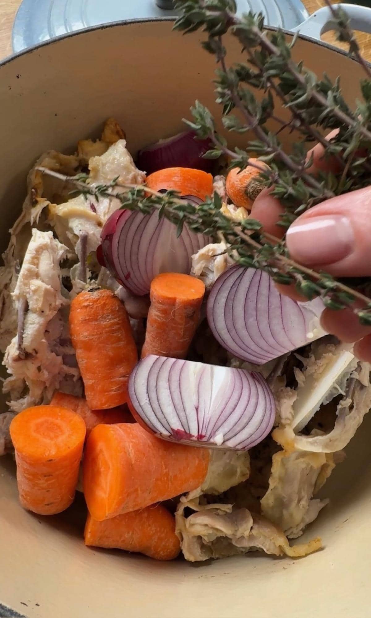 adding stock ingredients to a pot.