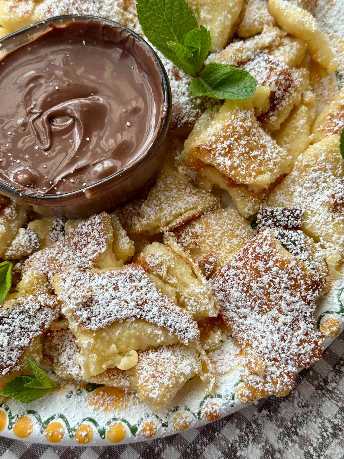 Kaiserschmarrn on a plate with powdered sugar.