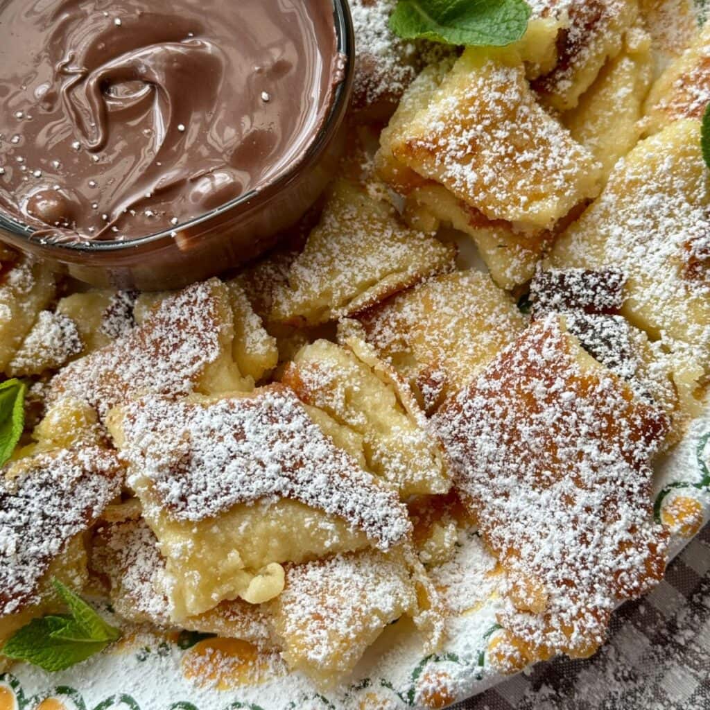 Kaiserschmarrn on a plate with powdered sugar.