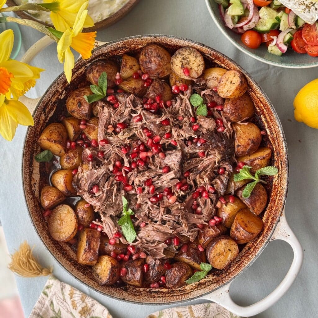 slow cooked lamb with potatoes in a tray.