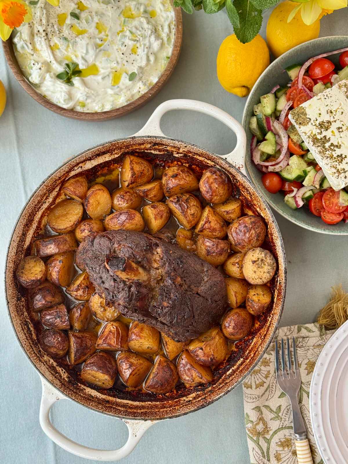 slow cooked lamb with potatoes in a tray.