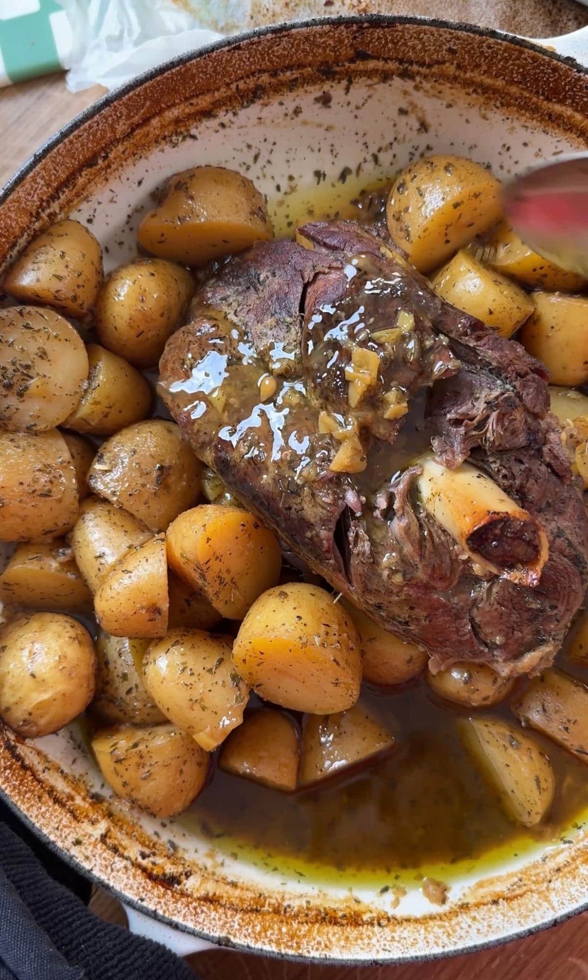 basting the leg of lamb.